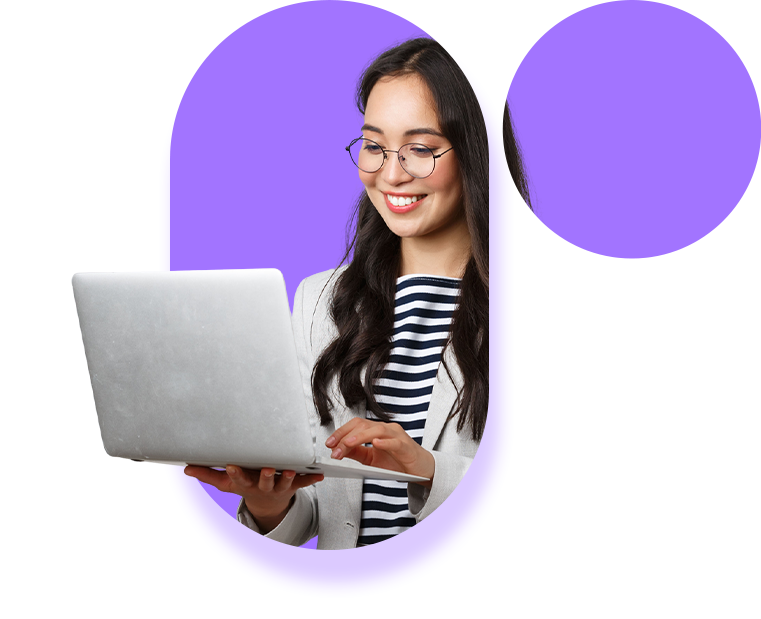 A woman with glasses holding a laptop smiling